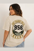 Woman wearing beige 956 El Alegre shirt with circular back design detail